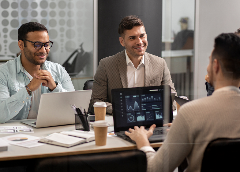 3 people having a discussion in a meeting room